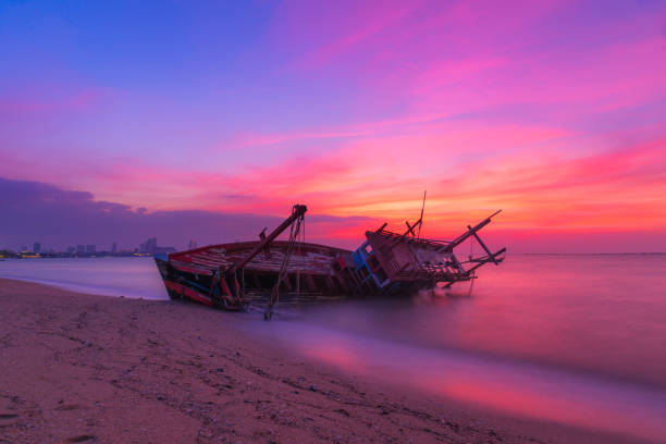 istock Long exposure  the old shipwreck have abandoned on beach with colorful twilight sky at sunset time 1077105340