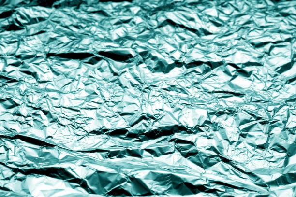 istock Metal foil texture with blur effect in cyan color. 1077105634