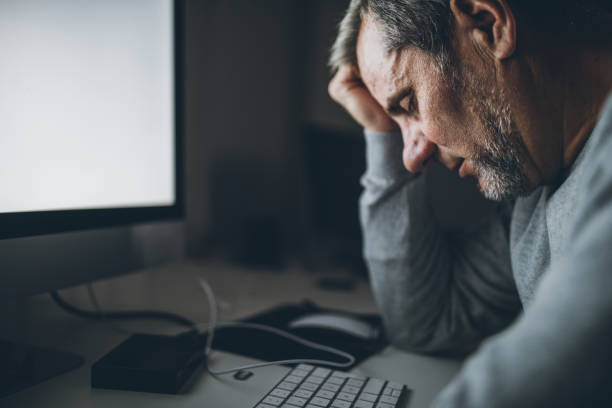 istock Senior man tired from working online 1077105838
