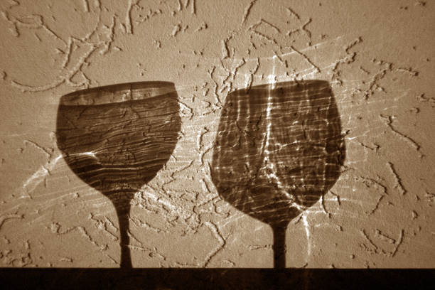 istock Two wine glasses shadow in brown tone. 1077111422