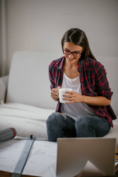 istock Young female architect working from home 1077111476
