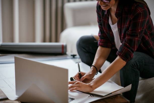 istock Young female architect working from home 1077111672