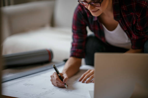 istock Young female architect working from home 1077113956