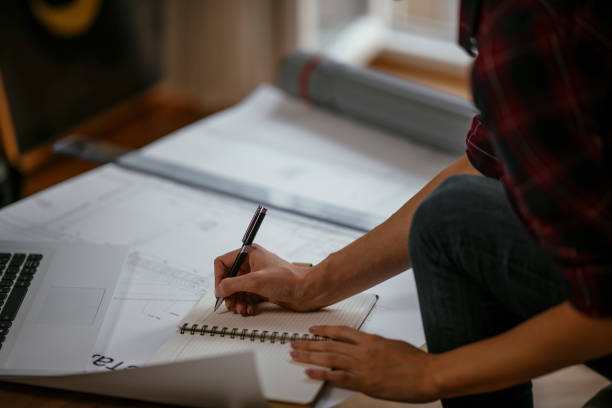 istock Young female architect working from home 1077114188