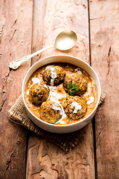 Malai Kofta is a Mughlai Speciality dish served in a bowl or pan over moody background. selective focus Malai Kofta is a Mughlai Speciality dish served in a bowl or pan over moody background. selective focus masala stock pictures, royalty-free photos & images