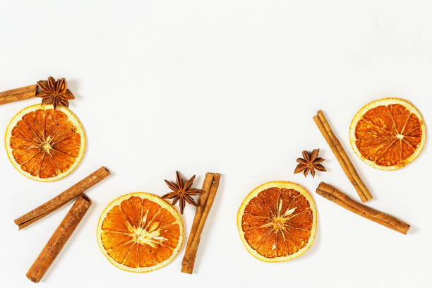 istock Dried oranges slices and cinnamon sticks on light background. Spices for hot wine. 1077116402