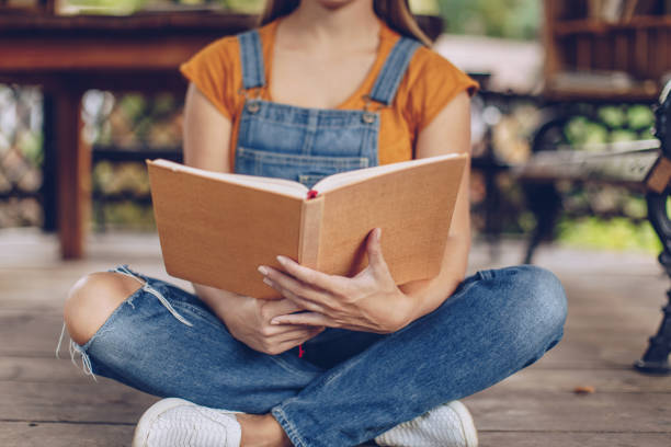 istock Reading a book outdoors 1077117062