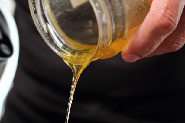 istock Pouring golden syrup. Making Shoofly Tart Series. 1077119570