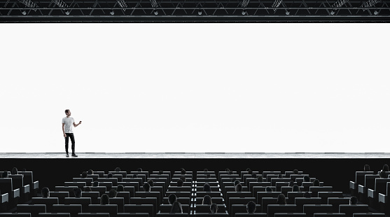 Presentation hall with person on scene auditorium watching on blank screen mockup. Empty display with speaker represent mock up. Public on training or forum template.