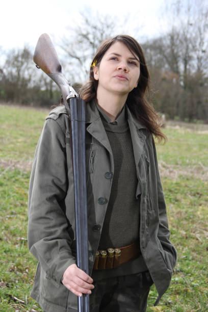 istock woman hunter with shotgun 1077121604
