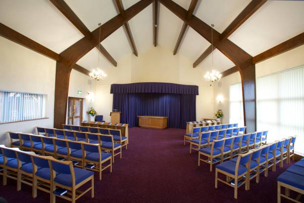 Funeral Chapel Interior of a crematorium chapel set out for a funeral service coffin crematorium stock pictures, royalty-free photos & images