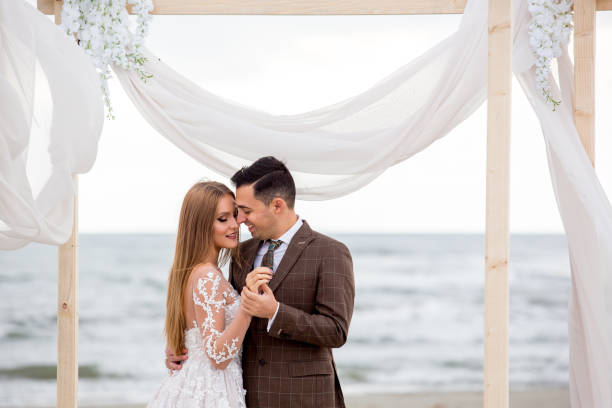 istock Beautiful wedding couple posing on beach 1077122604