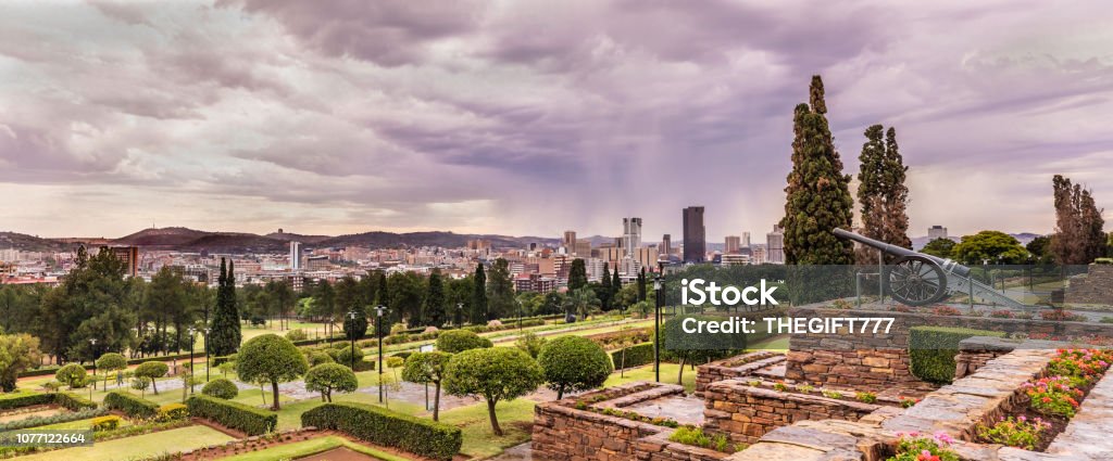 Pretoria cityscape under a stormy cloudscape Pretoria cityscape panorama under a moody sky with the Union Building gardens below.
Pretoria in South Africa is also known as "Jacaranda city" due to its trees planted in the city streets and parks. It is one of the capital cities, together with Cape Town and Bloemfontein. Pretoria is an academic city hosting three Universities. Pretoria Stock Photo