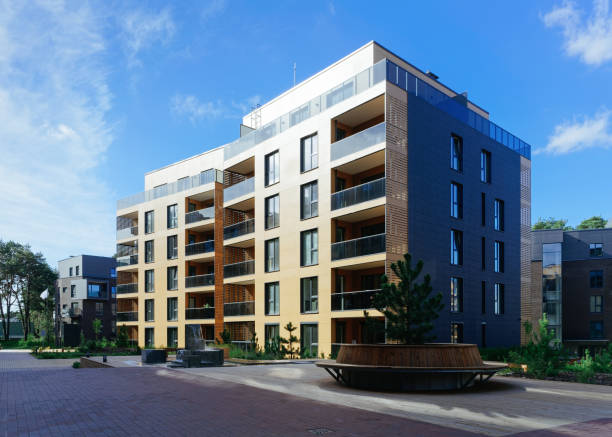 istock Pine tree at architectural complex of residential buildings 1077122986