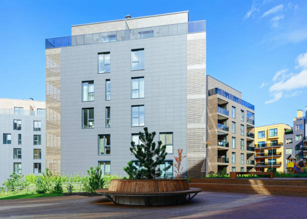 istock Pine tree at European architectural complex of apartment residential building 1077122992