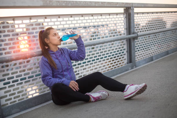 istock Woman drinking vitamin water 1077123184