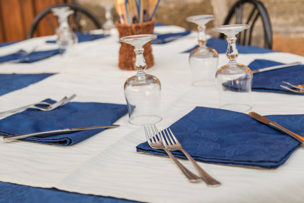 istock Restaurant set table with cutlery,  blue napkins and glasses 1077123384