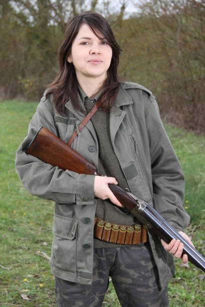 istock woman hunter with shotgun 1077127812