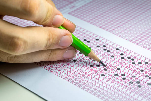 istock Exams quiz test paper with pencil drawing selected choice on answer sheets at school 1077131780
