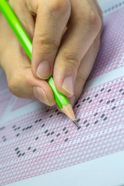 istock Exams quiz test paper with pencil drawing selected choice on answer sheets at school 1077131786