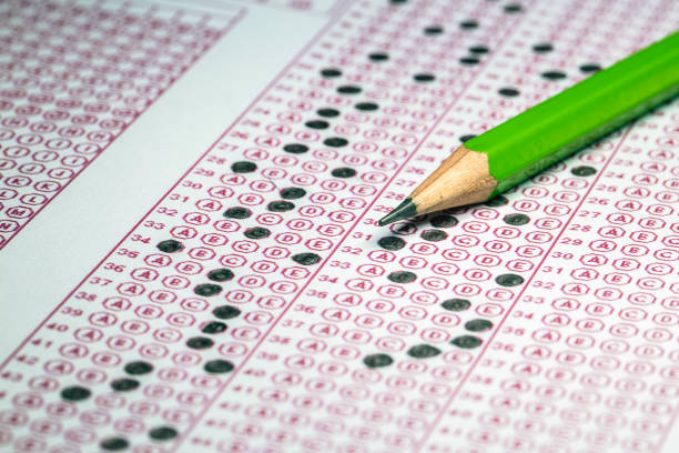 istock Exams quiz test paper with pencil drawing selected choice on answer sheets at school 1077131794