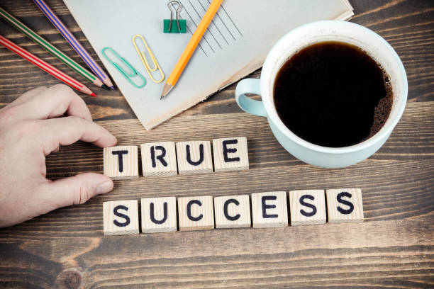 istock True Success. Wooden letters on the office desk 1077131804