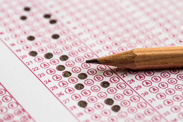 istock Exams quiz test paper with pencil drawing selected choice on answer sheets at school 1077131834