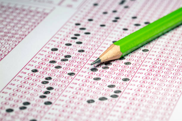 istock Exams quiz test paper with pencil drawing selected choice on answer sheets at school 1077132044
