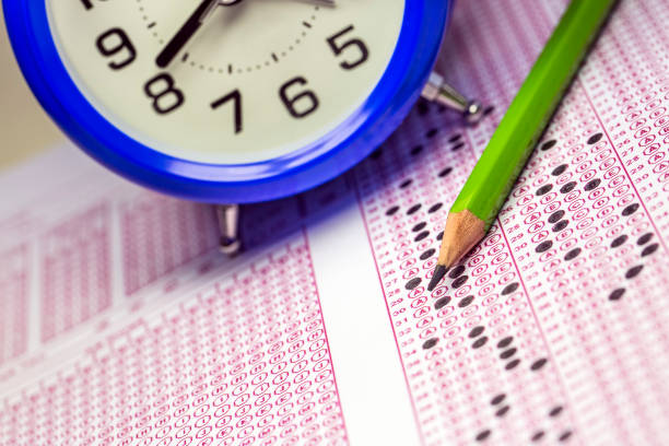 istock Exams quiz test paper with pencil drawing selected choice on answer sheets at school 1077132162