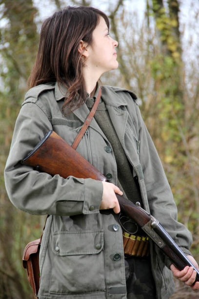 istock woman hunter with shotgun 1077132248
