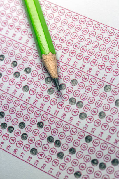 istock Exams quiz test paper with pencil drawing selected choice on answer sheets at school 1077132298