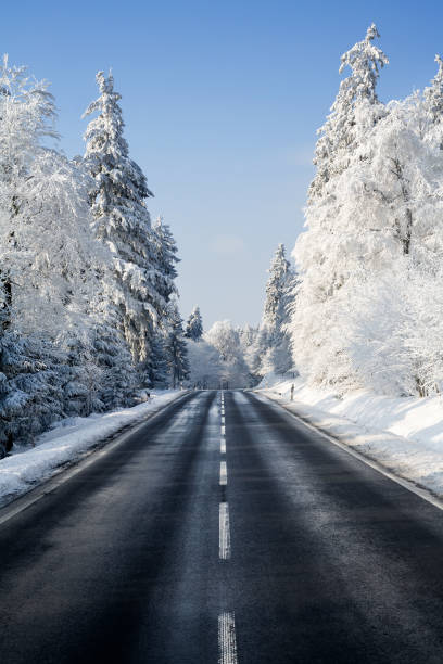 istock Road through winter forest - hoar frost 1077132370