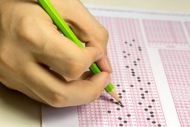 istock Exams quiz test paper with pencil drawing selected choice on answer sheets at school 1077132390