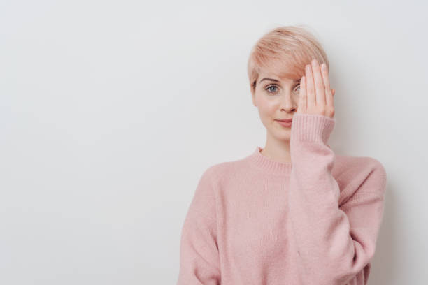 istock Attractive blond woman covering one eye 1077133304
