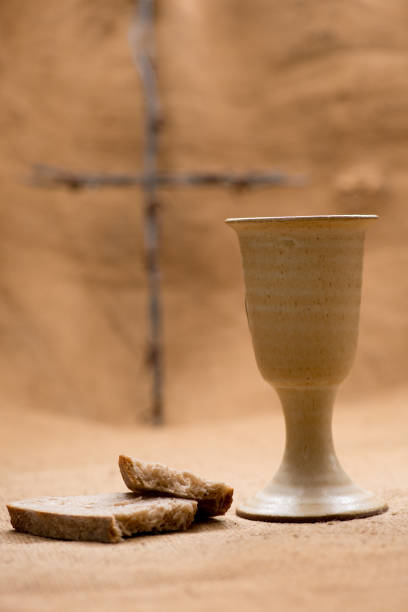 istock Chalice of wine with bread and cross 1077135836