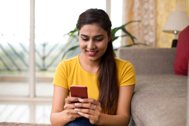 istock Beautiful woman texting on mobile phone 1077144488