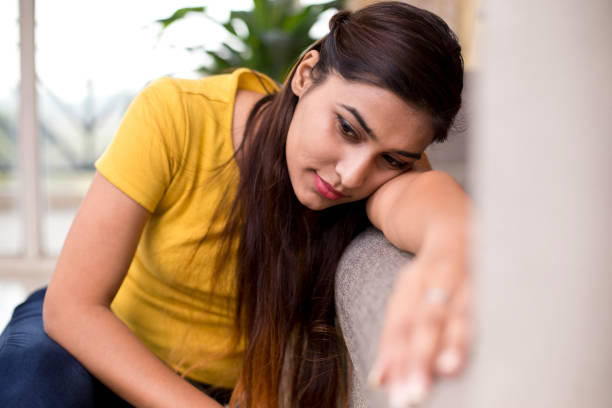 istock Beautiful woman resting on sofa 1077145180