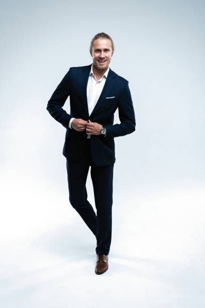 istock Perfect suit. Full length of handsome young man in suit looking at camera while standing against white background 1077146050