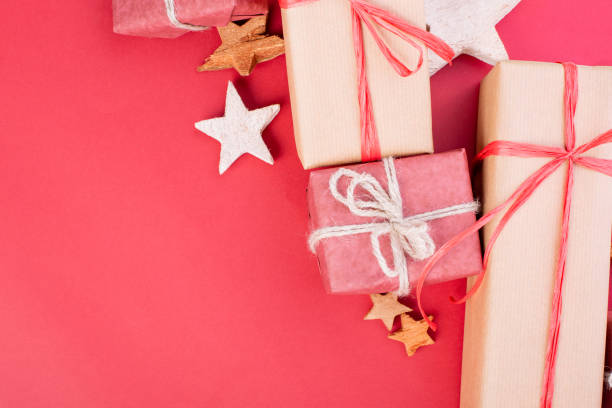 istock Christmas composition. Christmas red decorations, stars and gift boxes on red background. Flat lay, top view, space for the text 1077146270