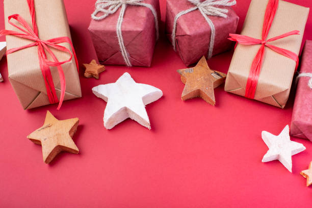 istock Christmas composition. Christmas red decorations, stars and gift boxes on red background. Flat lay, top view, space for the text 1077146278