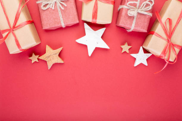 istock Christmas composition. Christmas red decorations, stars and gift boxes on red background. Flat lay, top view, space for the text 1077146284