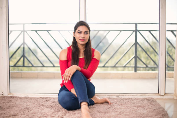 istock Beautiful woman sitting at home 1077148054