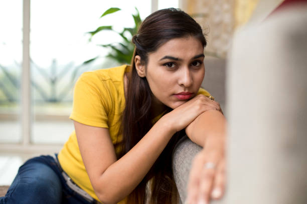 istock Beautiful woman resting on sofa 1077149646