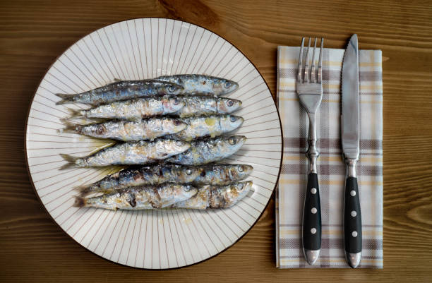 istock grilled sardine plate on wooden table 1077149994