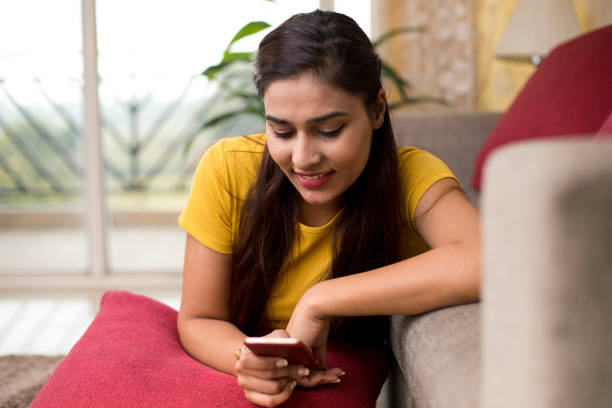istock Beautiful woman texting on mobile phone 1077150572