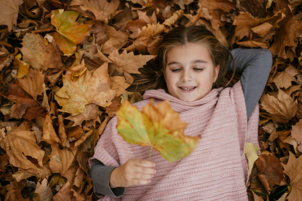 istock Girl in autumn park 1077151452