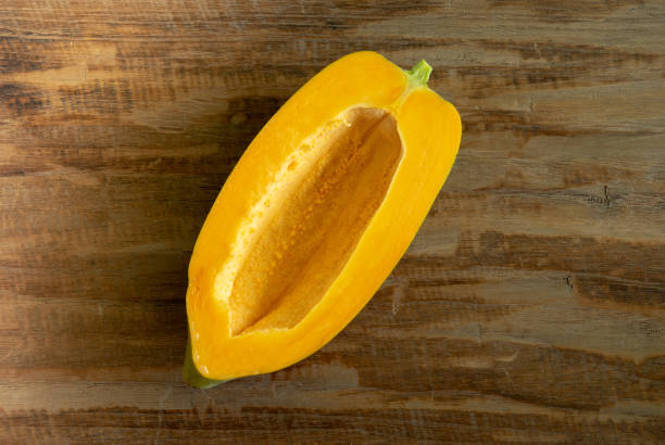 istock papaya slices without seed on wooden background. top view 1077153262
