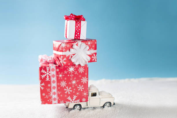 istock Crhistmas card with toy car and red gift boxes on snow 1077154322
