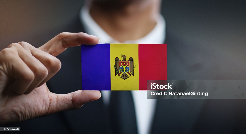 Businessman Holding Card of Moldova Flag Adult Stock Photo