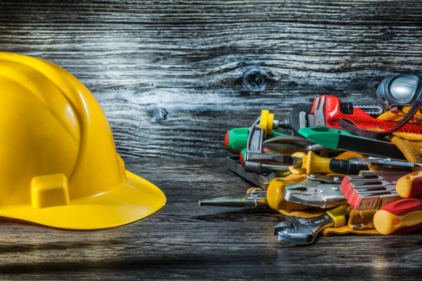 istock construction helmet and set of tools on vintage wood. 1077157914
